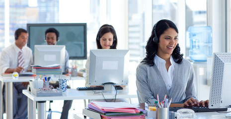 Businesswoman in a call center with her colleagues