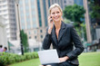 © EastWest Imaging - Businesswoman with Phone and Laptop