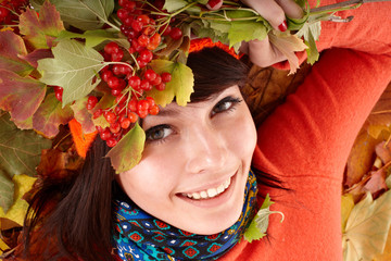 Wall Mural - girl in autumn orange hat on leaf group and berry.