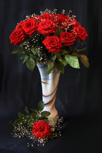 Bouquet Of Red Roses In A Decorative Vase On A Black Background