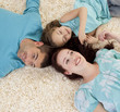 © WavebreakMediaMicro - Parents and daughter on floor with heads together