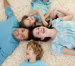 © WavebreakMediaMicro - Smiling family on floor with heads together