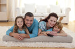 © WavebreakMediaMicro - Smiling family on floor in living-room