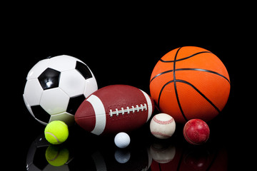 Wall Mural - Assorted sports balls on a black background