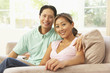 © Monkey Business - Young Couple Relaxing On Sofa At Home