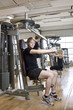 © gemenacom - Young man using an exercise machine