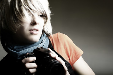 Young beautiful woman taking a photo with a digital camera