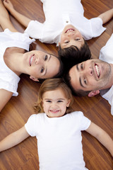 Wall Mural - Family lying on floor with heads together