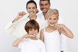 © WavebreakMediaMicro - Portrait of family cleaning their teeth in bathroom