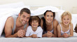 © WavebreakMediaMicro - Family playing in parent's bed