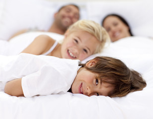 Wall Mural - Family resting in parent's bed