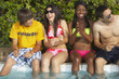 © Trevor Lush/Blend Images - Multi-ethnic group of friends enjoying pool party