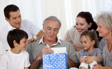 Wall Mural - Family giving to grandfather a present