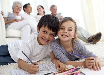 Wall Mural - Children painting on floor with their family in sofa