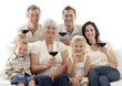 © WavebreakMediaMicro - Family in living-room drinking wine and eating biscuits