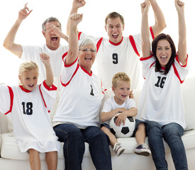 Wall Mural - Family celebrating a goal at home