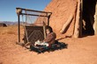 Navajo Child Sitting Next to Traditional Rug Making Tools
