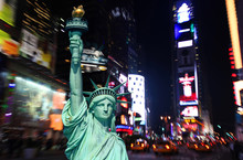 The Statue Of Liberty And Times Square