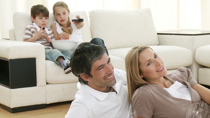 Wall Mural - Family in living-room watching television