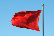 Red Warning Flag At The Beach