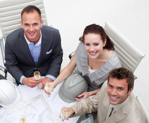 Happy architects drinking champagne in the office