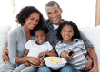 © WavebreakMediaMicro - Afro-American family watching television at home