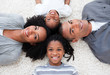 © WavebreakMediaMicro - Smiling Afro-American young family lying on floor