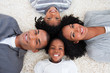 © WavebreakMediaMicro - Afro-American family on floor with heads together
