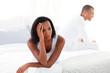 © WavebreakMediaMicro - Upset young couple sitting on bed separately