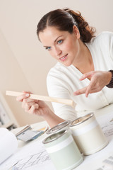 Wall Mural - Female interior designer with cans of paint at office