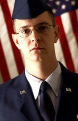 Soldier standing in front of American flag