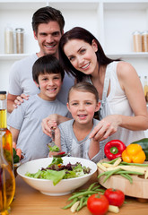 Smiling family cooking together