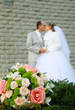 Walk honeymooners, wedding bridal bouquet in the foreground