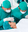 © WavebreakMediaMicro - Close-up of surgeons near patient lying on operating table