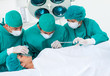 © WavebreakMediaMicro - Surgeons near patient lying on an operating table