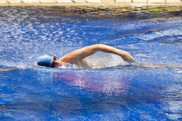 The young sports swimmer in pool