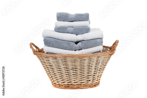 Fotografie, Obraz Wicker laundry basket full of white and gray towels
