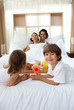 © WavebreakMediaMicro - Happy children bringing a breakfast to their parents