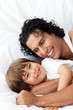 © WavebreakMediaMicro - Happy father and his little boy lying on the bed
