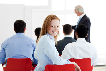 Smiling caucasian businesswoman at a conference