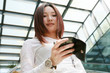 © zhu difeng - young asian businesswoman holding mobile phone