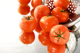 Fototapeta Kuchnia - dojrzale czerwone pomidory w sitku, na białym tle, mokre, lustro