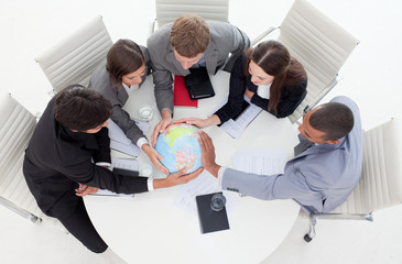 Wall Mural - High angle of a business people holding a terrestrial globe