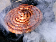 Sausage On Barbecue With Wooden Coals