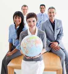 Wall Mural - Cheerful multi-ethnic business people holding a terrestrial glob