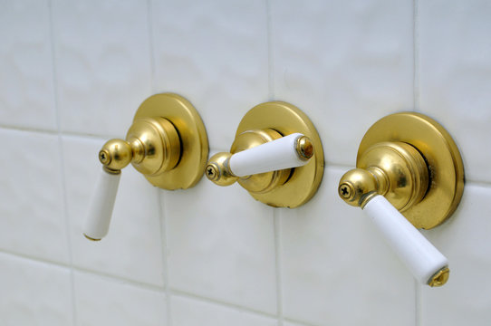 Wall Mural -  - Three golden shower valve handles