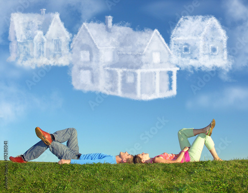 Fotografía lying couple on grass and dream three cloud houses collage