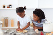 © WavebreakMediaMicro - Jolly siblings cooking biscuits