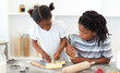 © WavebreakMediaMicro - Concentrated brother and sister cooking biscuits