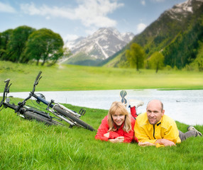 Wall Mural - two cyclists on river bank